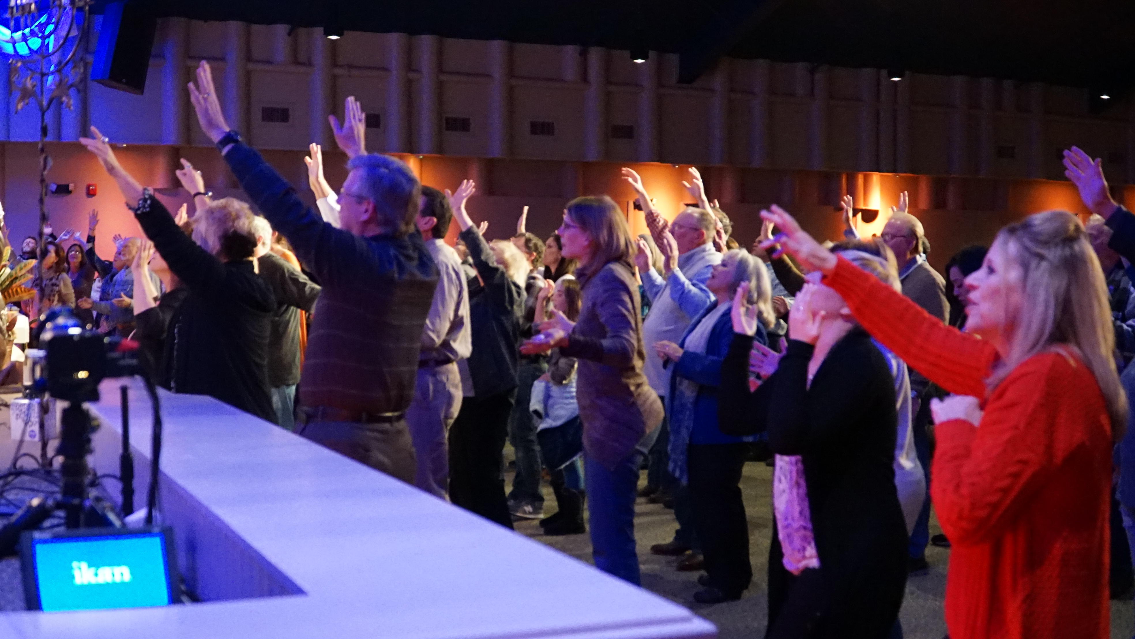 CLM hands raise worship sing prayer fellowship hall