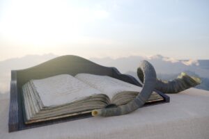Hebrew Bible opened on outside podium with a shofar lying beside it.